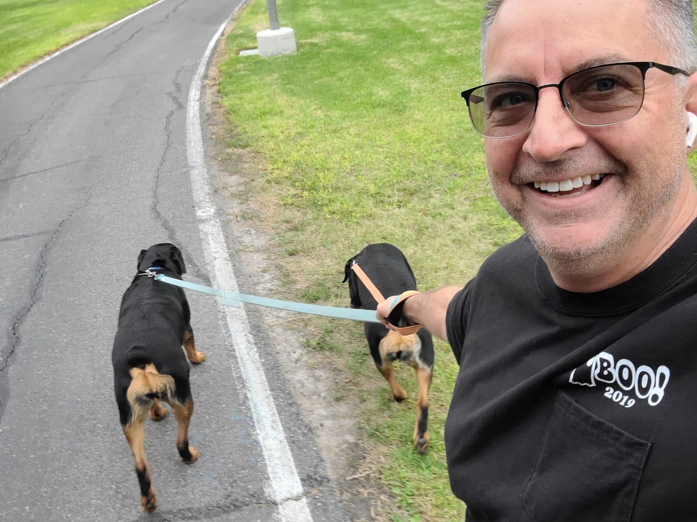 October 2021. Walking his two Rottweilers, Brie and Ella, simultaneously. They are in charge. He is aware of this.